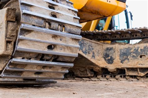 compact excavator tracks on lawns|rubber vs steel track traction.